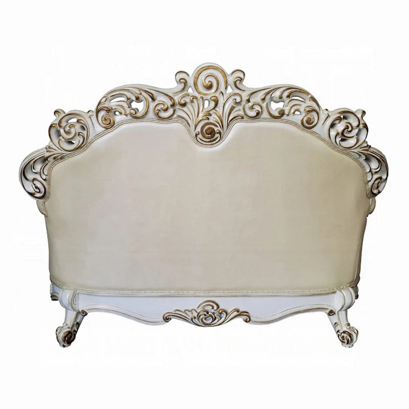 Causeuse traditionnelle capitonnée en similicuir couleur champagne avec 3 coussins pour 2 personnes